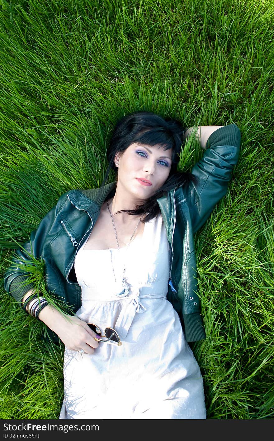 Young model laying in the grass. Young model laying in the grass