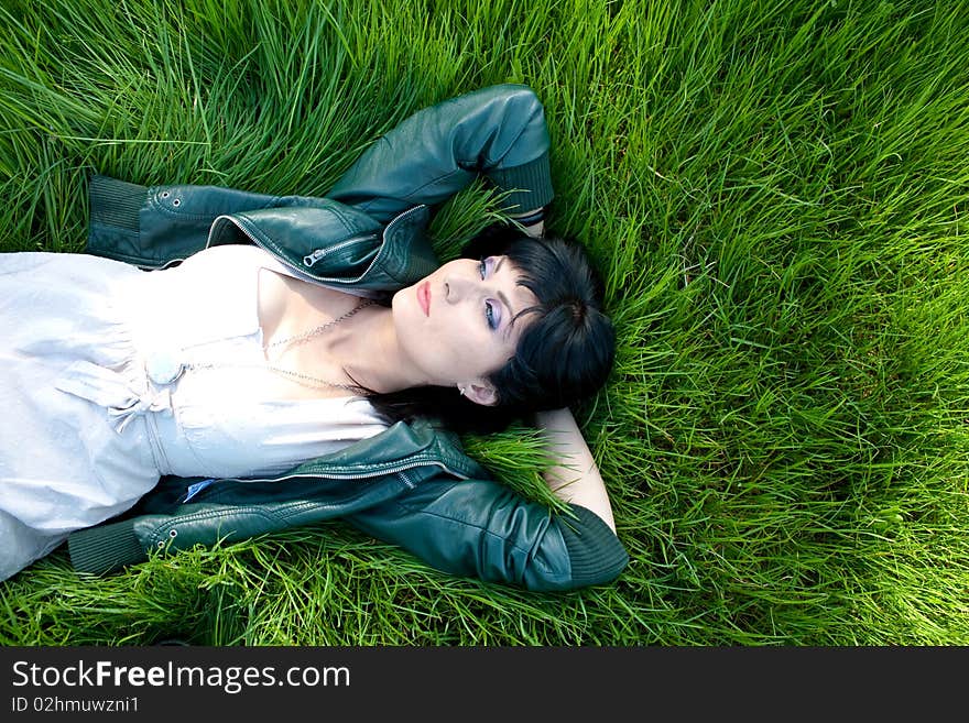 Young model laying in the grass. Young model laying in the grass