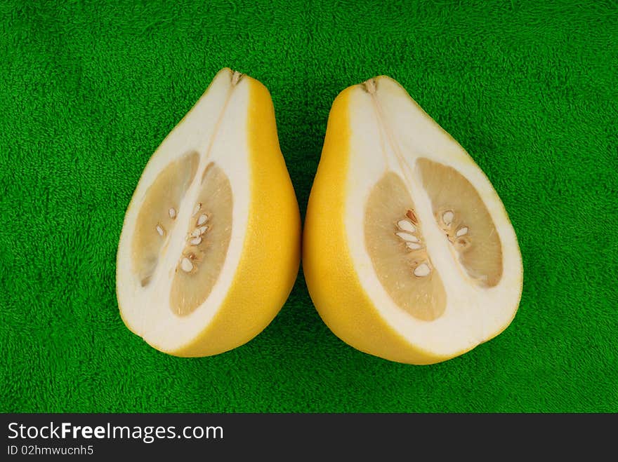 Pomelo lie on green towel