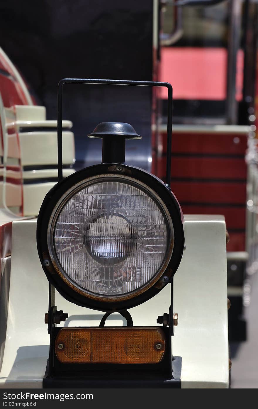 A completed head light of a small train in red and white color, and interesting shape. A completed head light of a small train in red and white color, and interesting shape.