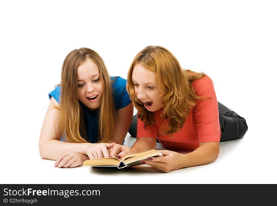 Two surprised girls read the book, isolated on white. Two surprised girls read the book, isolated on white