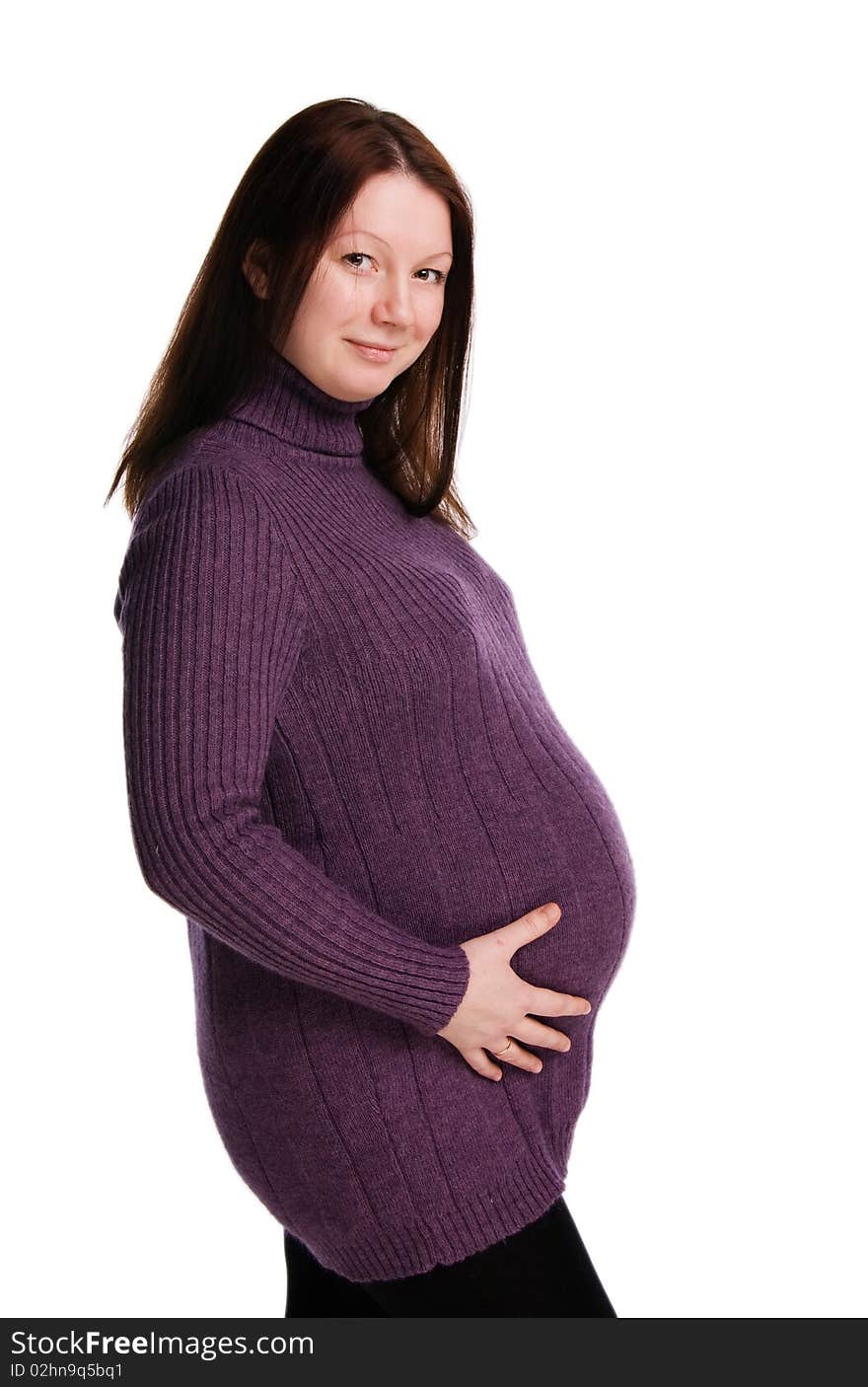 The beautiful pregnant woman in a violet sweater embraces stomach, isolated on white. The beautiful pregnant woman in a violet sweater embraces stomach, isolated on white