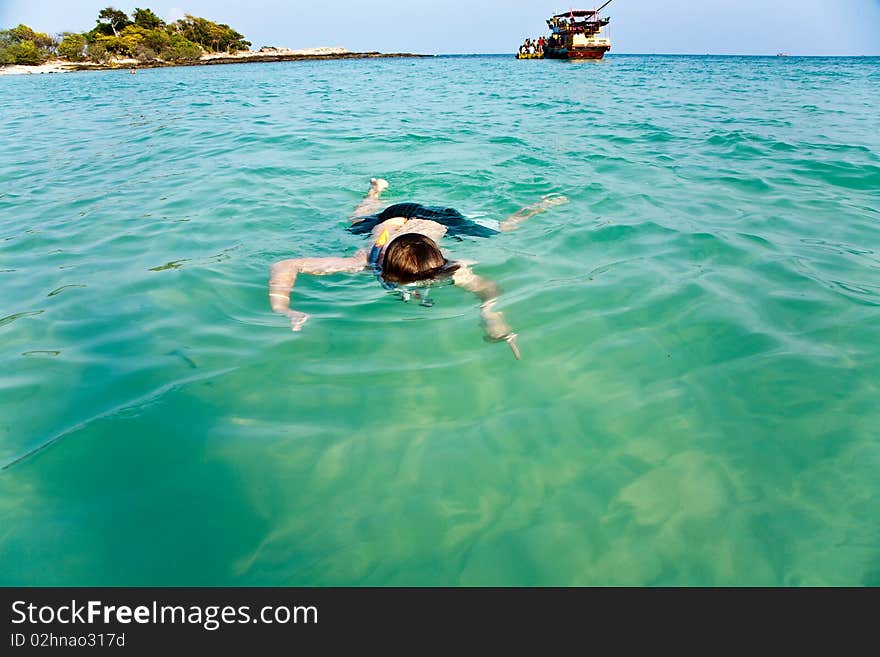 Young boy likes to snorkel in the clear water at the beautiful beach. Young boy likes to snorkel in the clear water at the beautiful beach