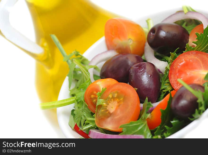 Salad with cherry tomatoes, onion and olives -white background