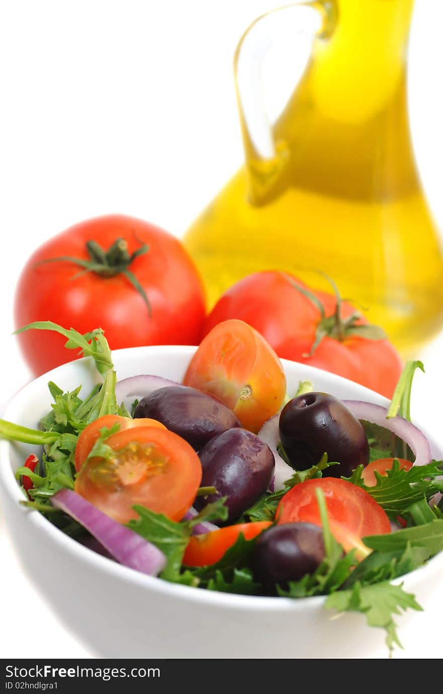 Salad with cherry tomatoes, onion and olives -white background