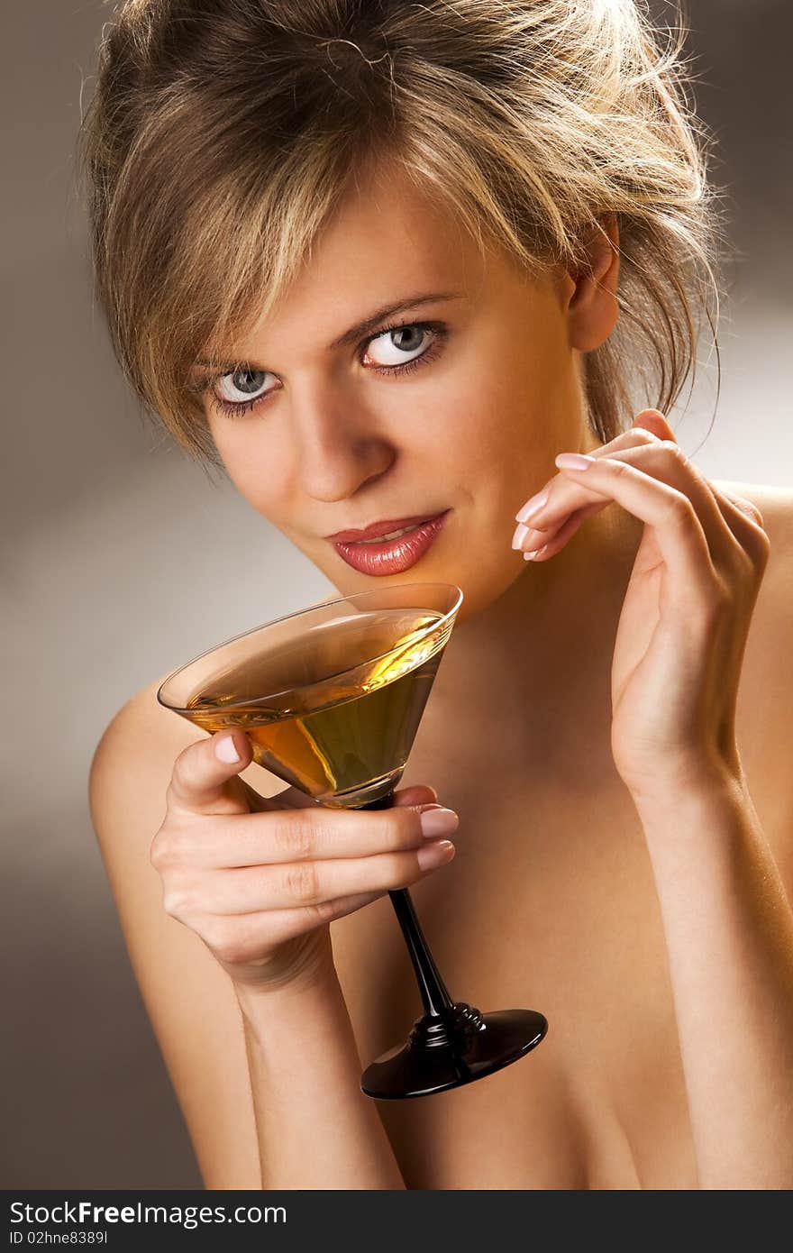 Beautiful alluring woman with glass of cocktail