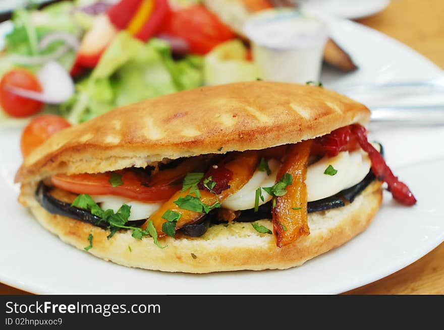 Baked sandwich with eggs and vegetables on white plate