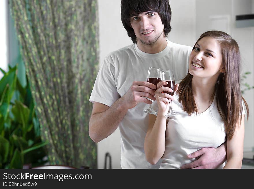 Beautiful girl with smile and boy with wineglasses