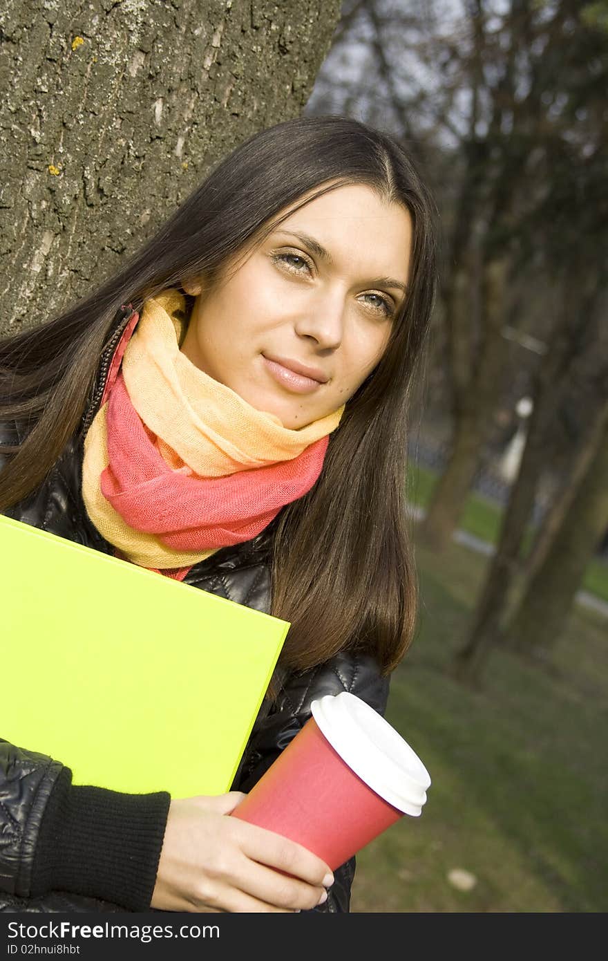 Beautiful elegant female strolling with documents and folders with a glass of hot coffee. Beautiful elegant female strolling with documents and folders with a glass of hot coffee