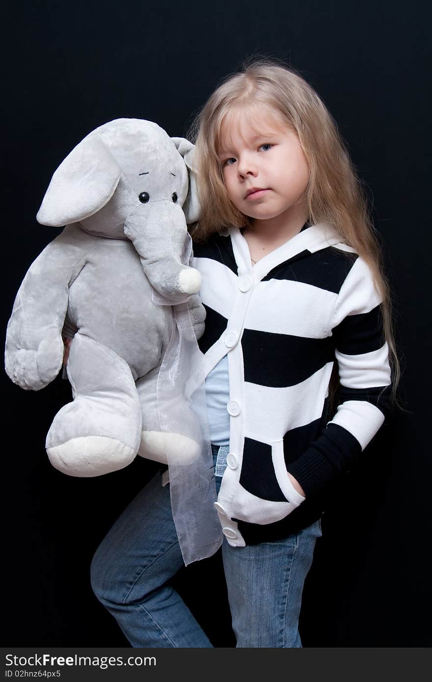 Little girl holds toy like elephant. Little girl holds toy like elephant