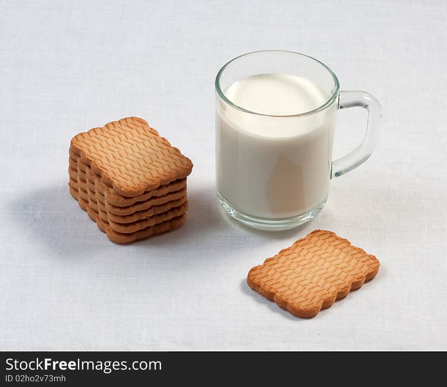 Glass cup of milk and cookies on table