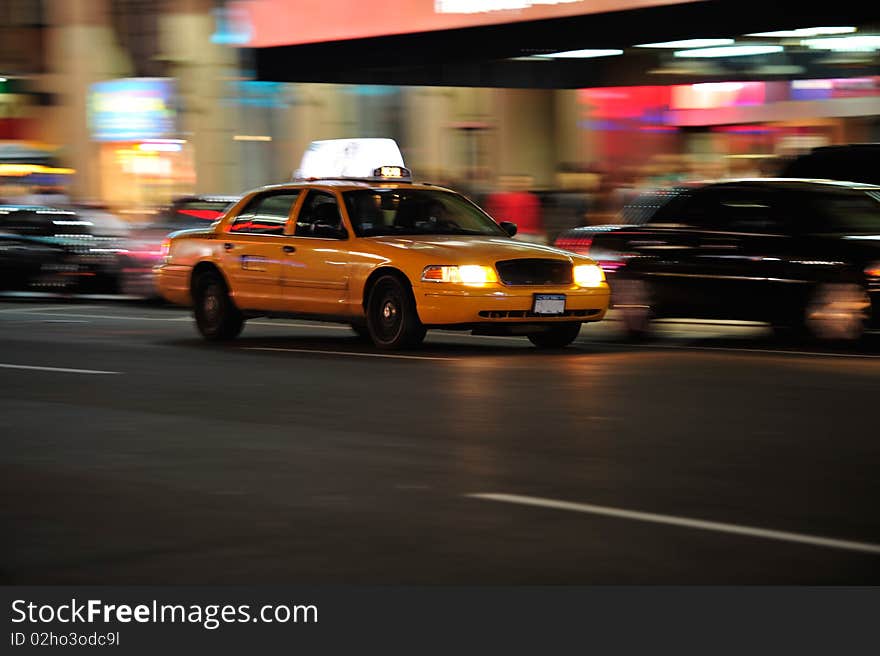 Yellow cab in motion at night in NYC. Yellow cab in motion at night in NYC.