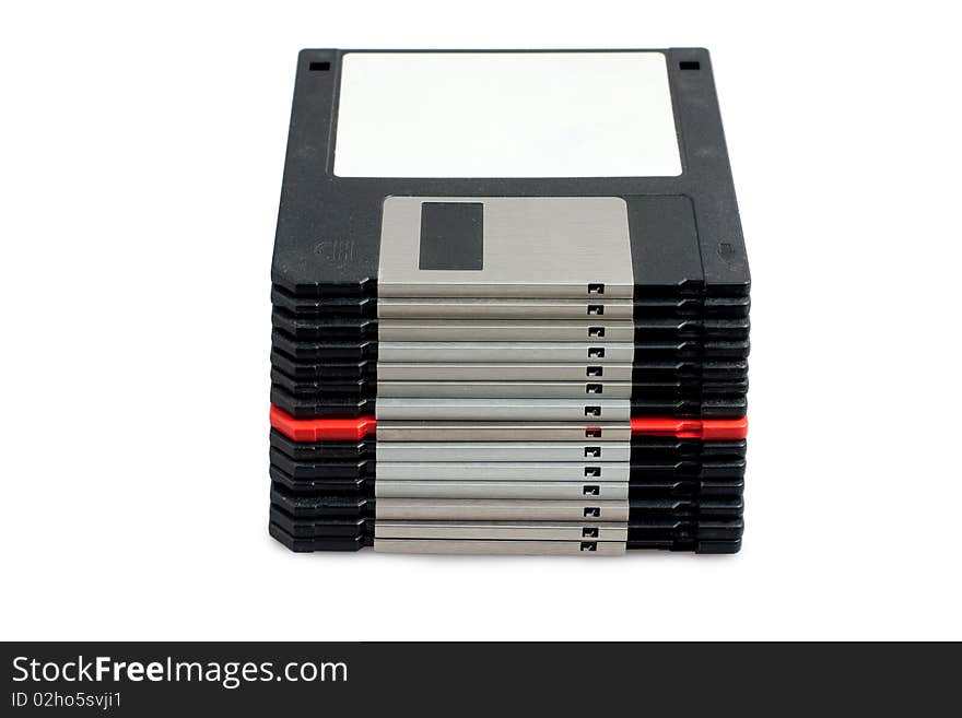 Stack of black floppy disks and one red on white background