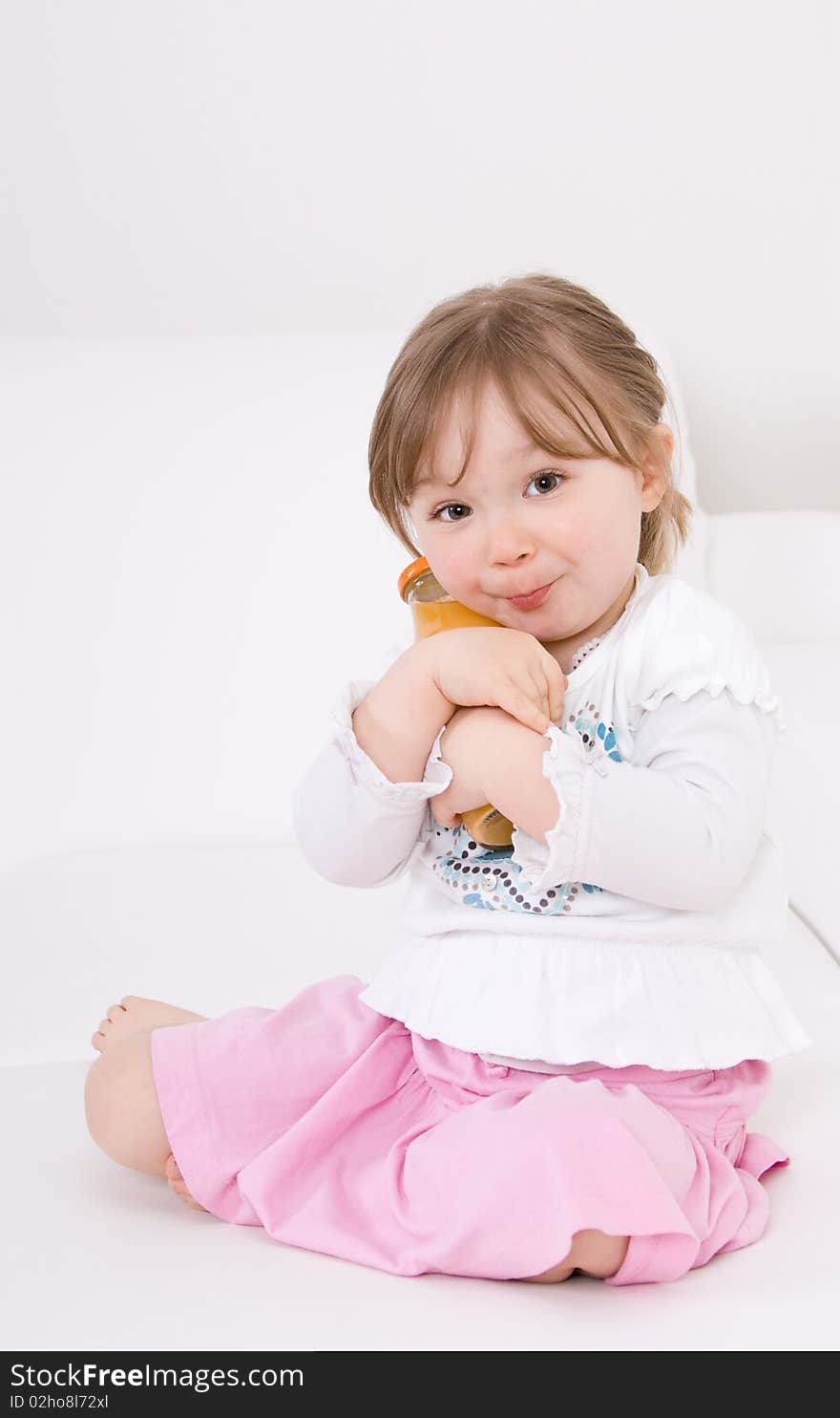 Happy little girl on white sofa. Happy little girl on white sofa