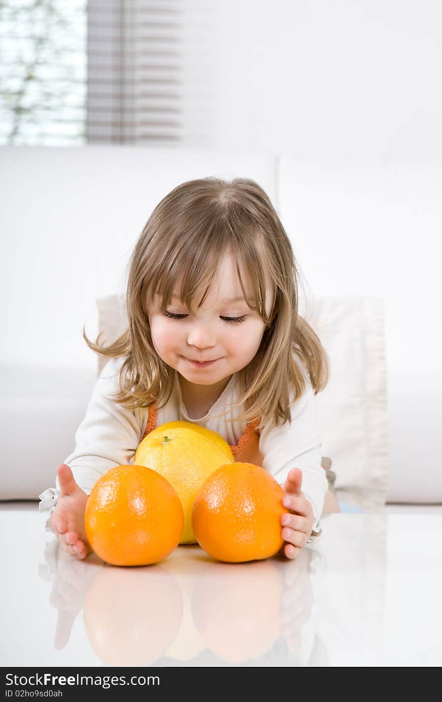 Happy little girl with fruits