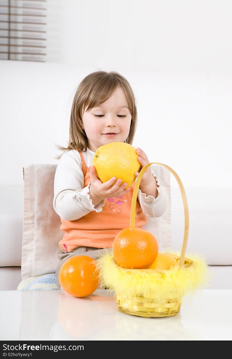 Happy little girl with fruits