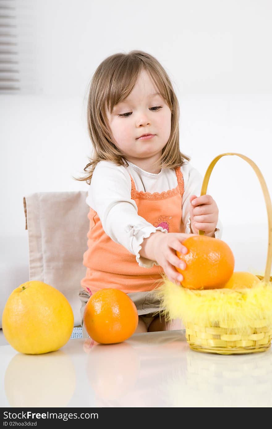 Happy little girl with fruits