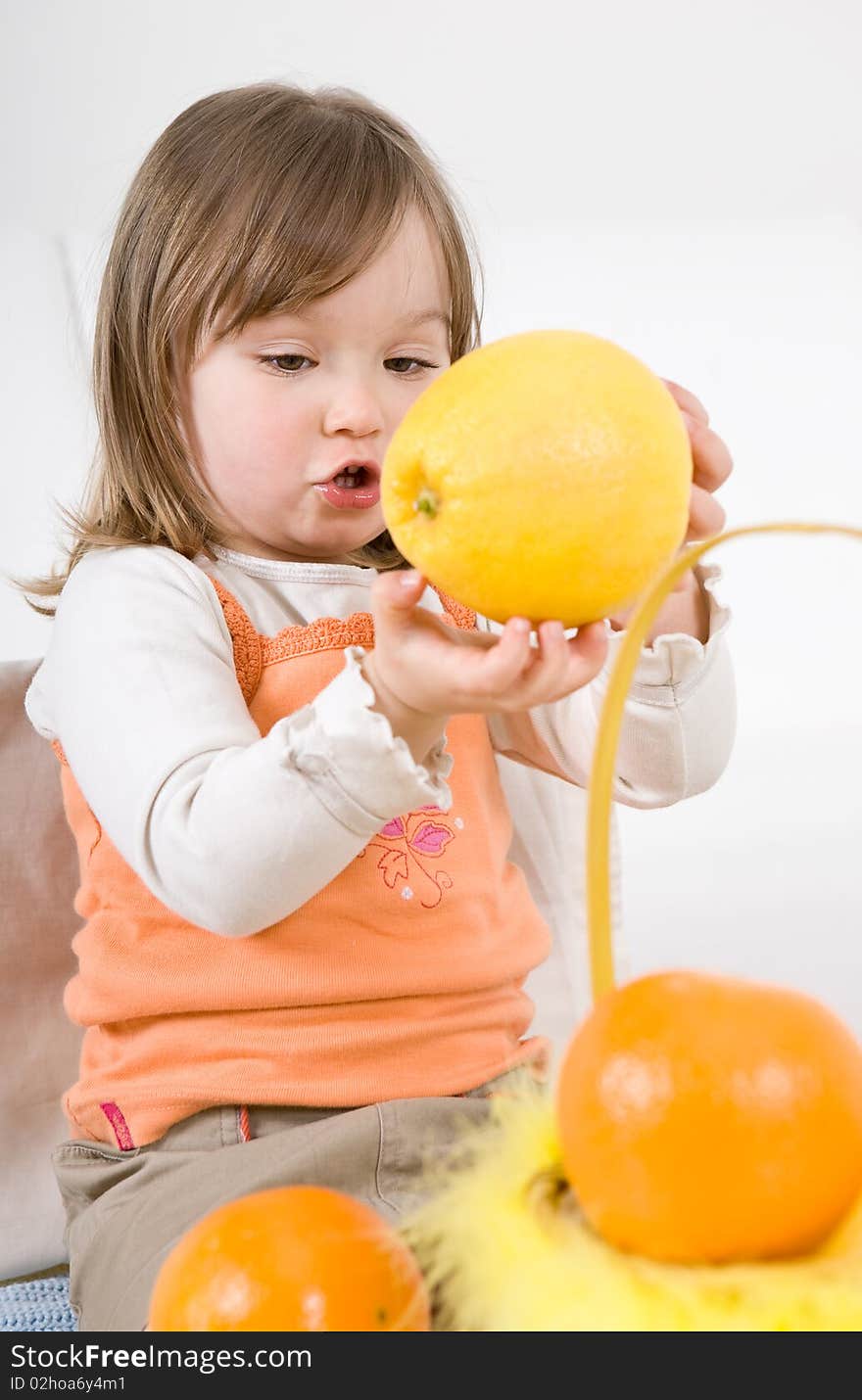 Happy little girl with fruits