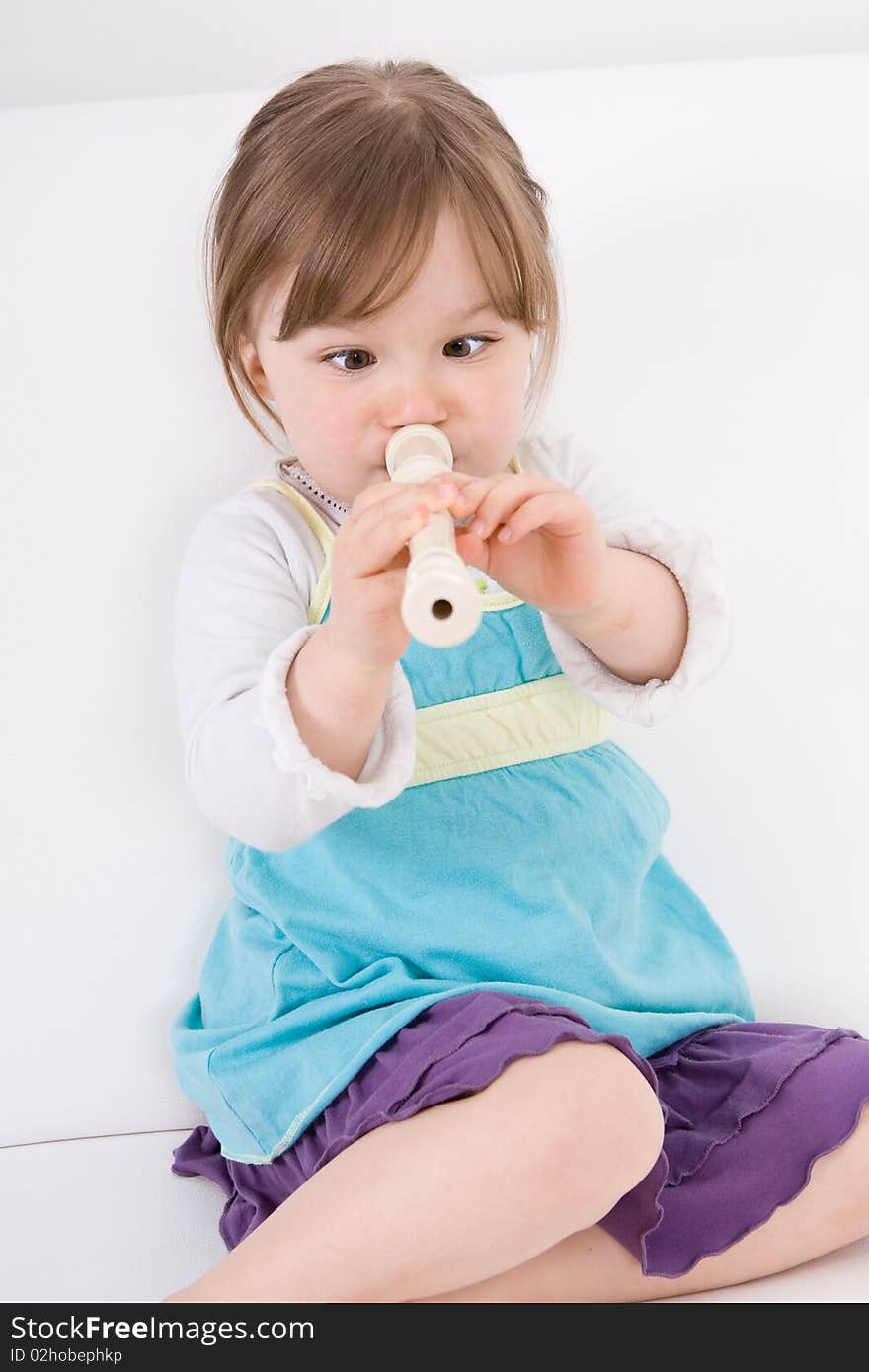 Little happy girl with flute