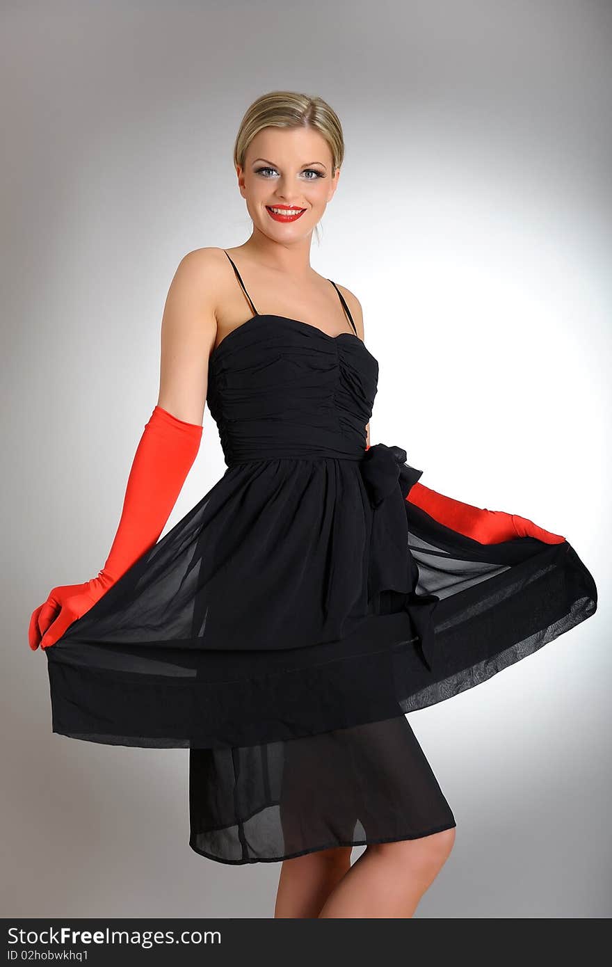 Sexy fashion woman with red gloves in dress