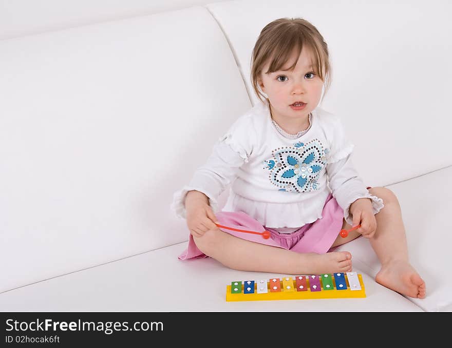 Sweet toddler little girl with instrument