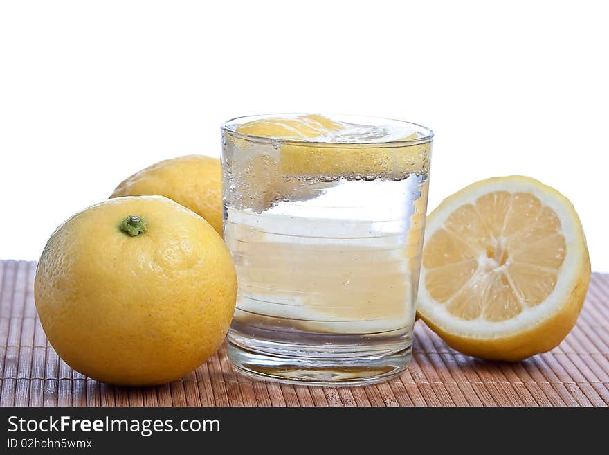 Lemon fruits with glass isolated on white. Lemon fruits with glass isolated on white