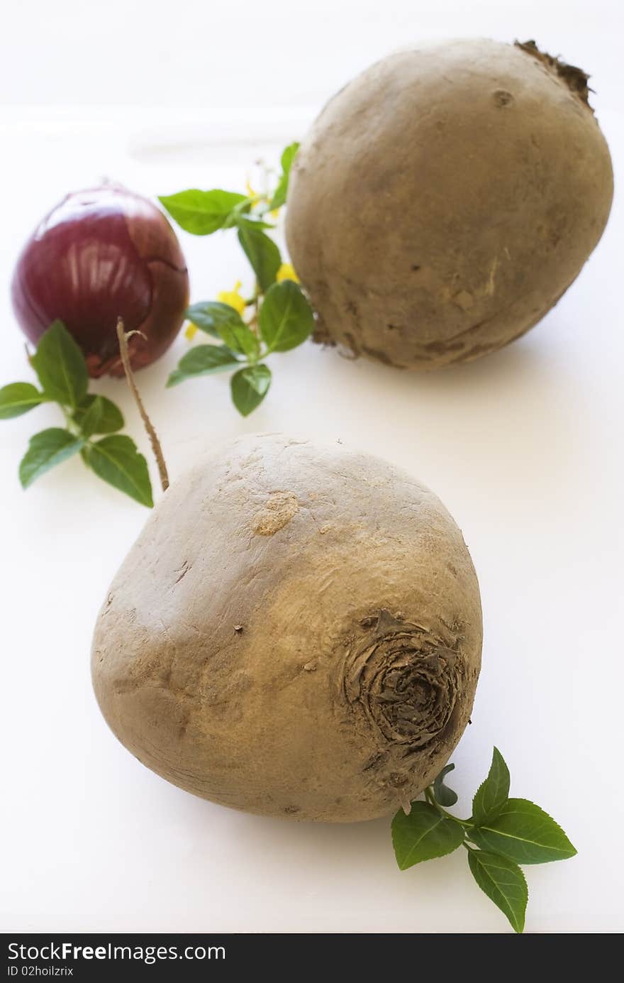 Beetroot and onion on white cutting board