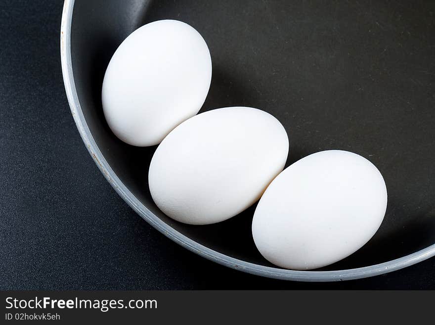 Three eggs of a hen on a frying pan