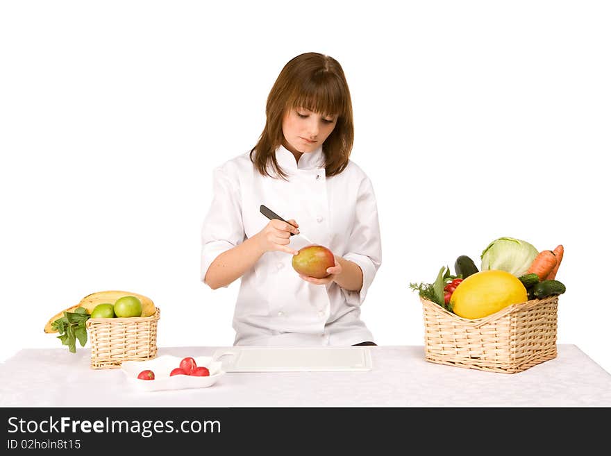 Cook girl makes carving a mango isolated on white background