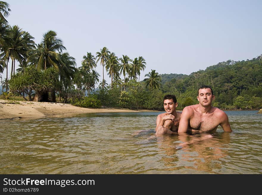 Two men in jungle lagoon