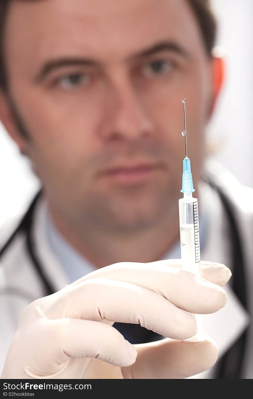 Professional doctor with medical syringe in hands, getting ready for injection