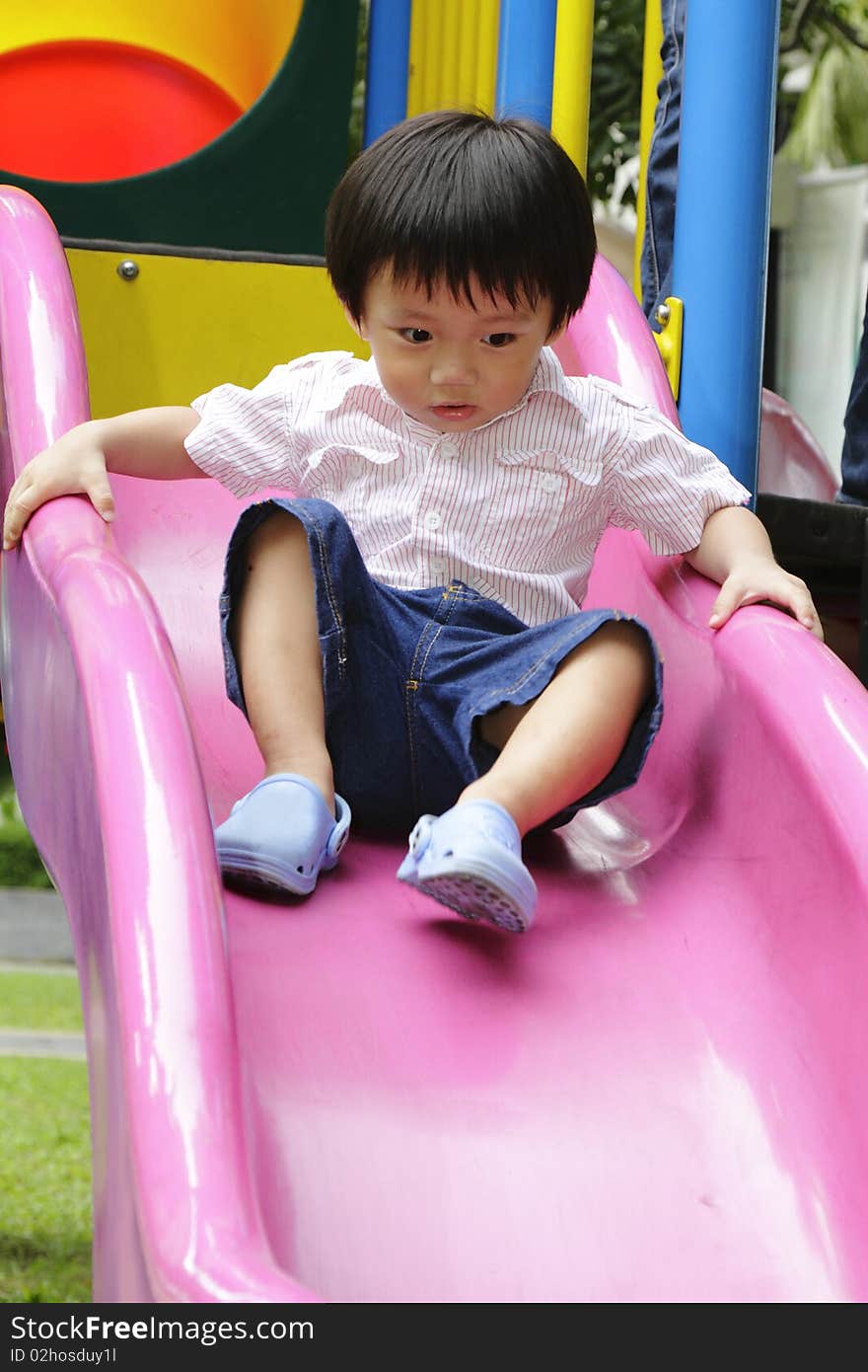 Cute Asian boy in a playground