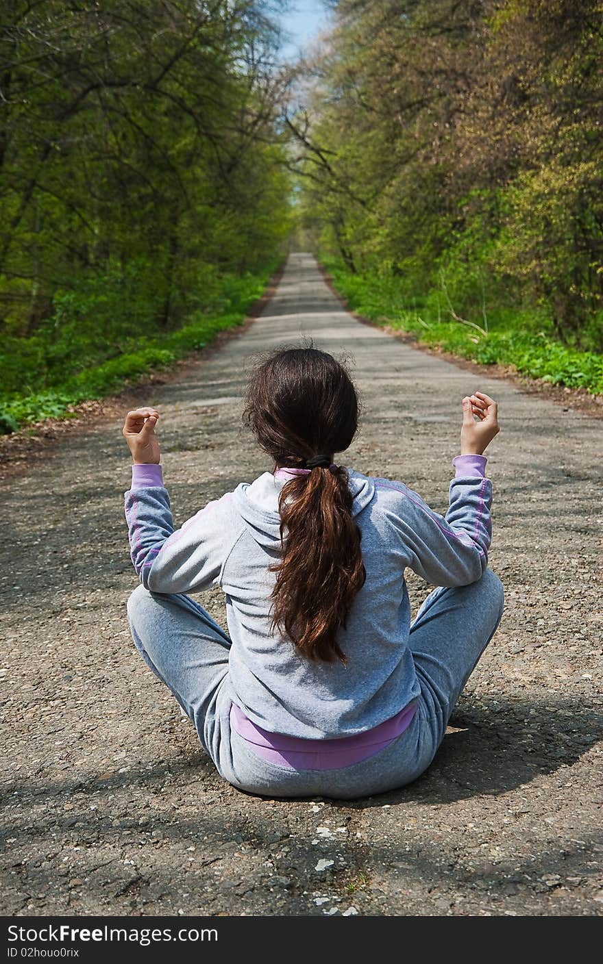 Girl Meditating, Sitting In The Middle Of The Road