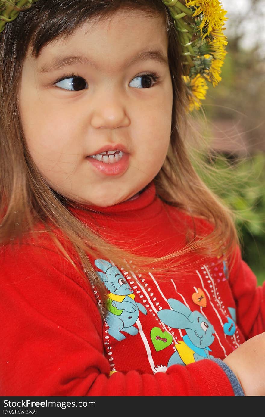 Closeup of a little girl wearing a dandelion diadem. Closeup of a little girl wearing a dandelion diadem