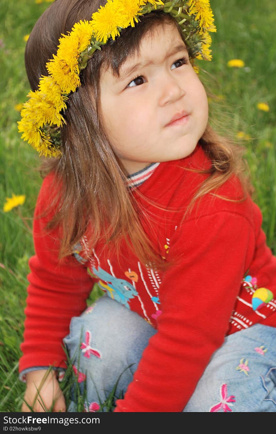 Little girl wearing a dandelion diadem saw smth in the sky. Little girl wearing a dandelion diadem saw smth in the sky