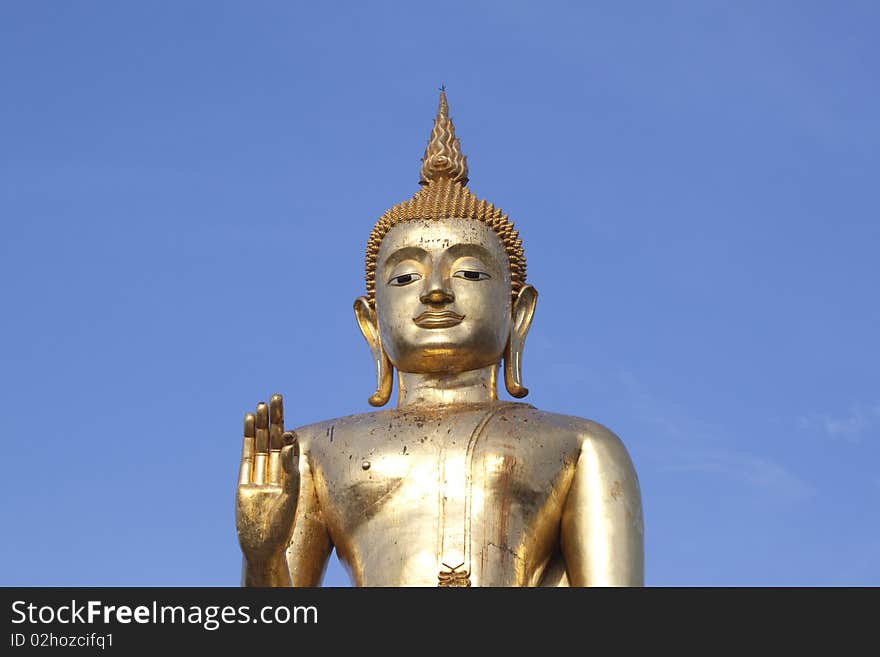 Buddha in Thailand with blue sky