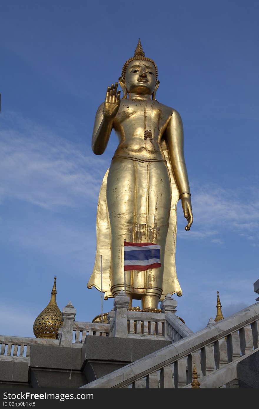 Buddha in Thailand with blue sky