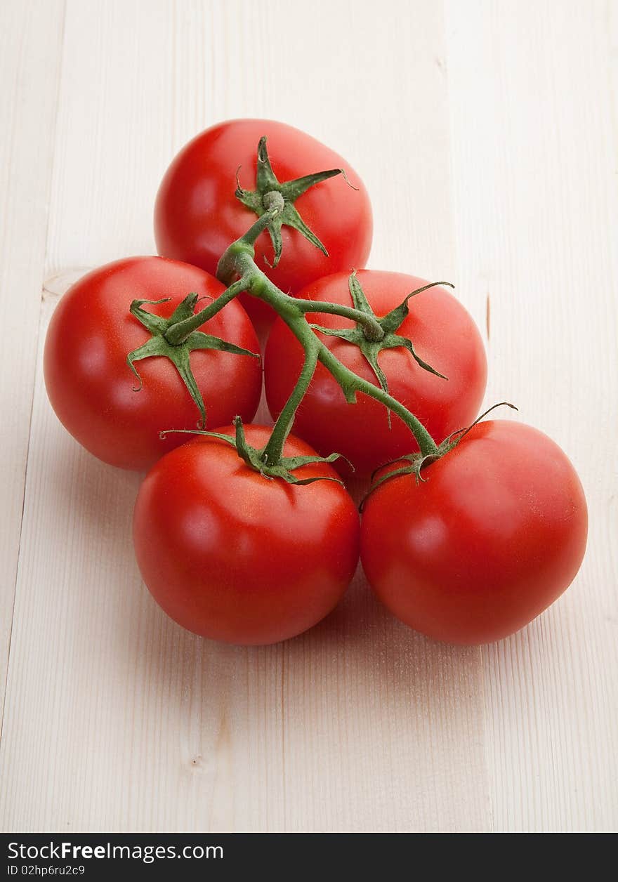 Red beauty tomatoes on wood