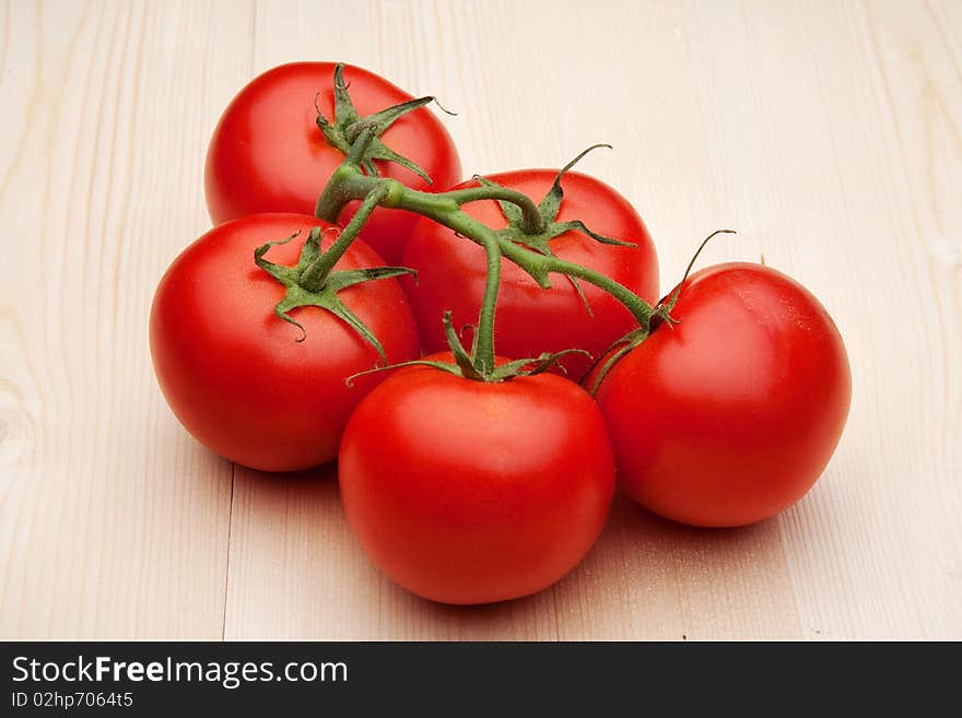 Beauty tomatoes on branch in studio. Beauty tomatoes on branch in studio