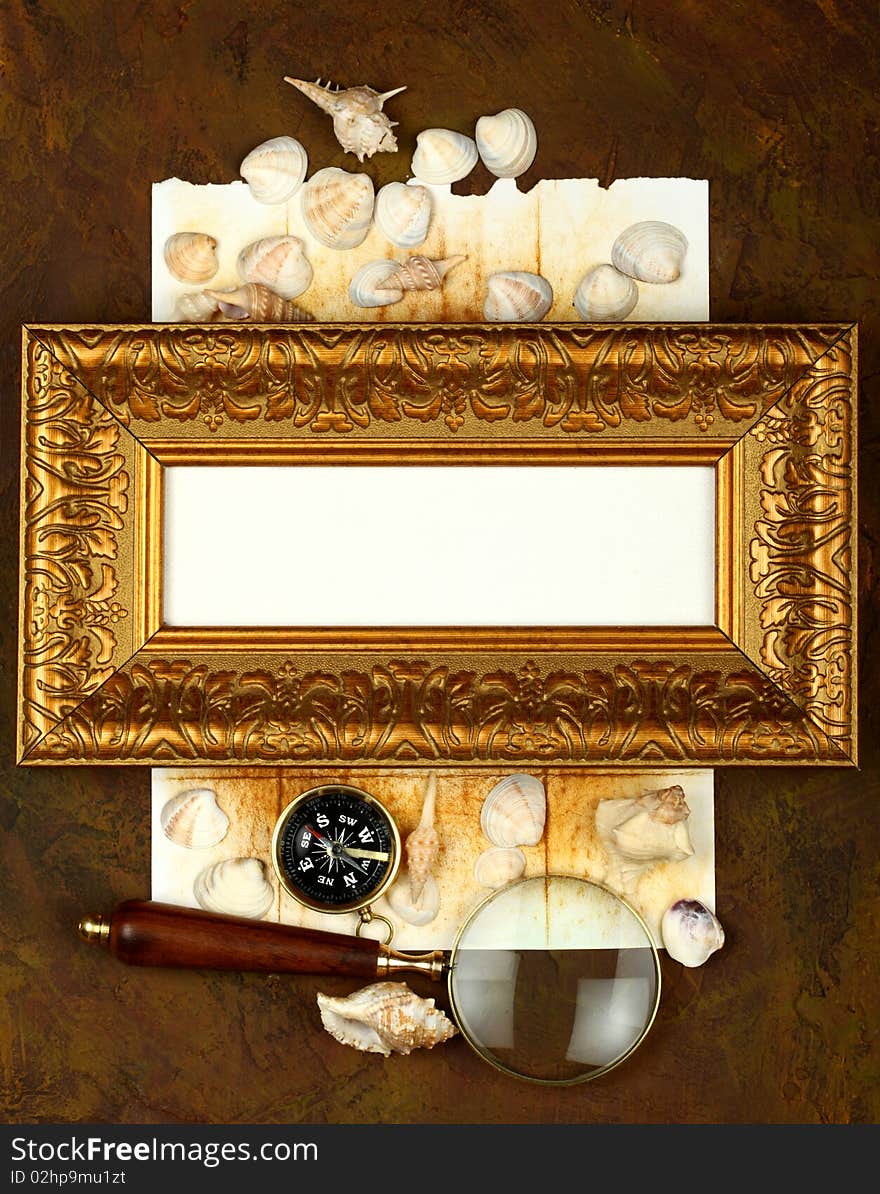 Antique frame with a compass, cockleshells and a magnifier