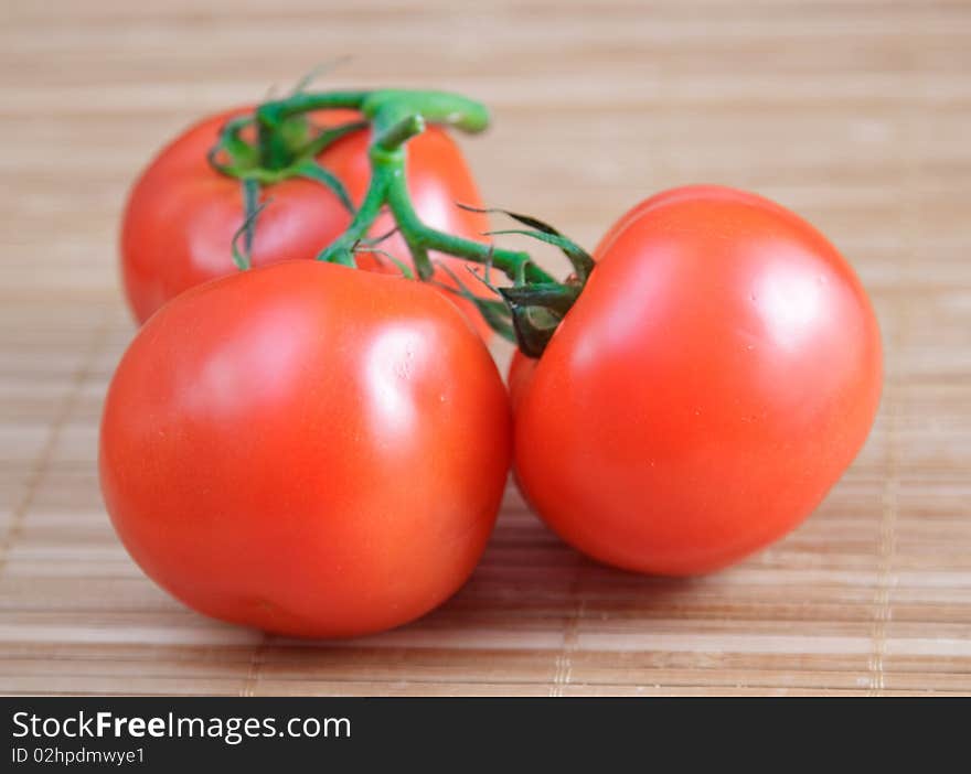 Red salad and tomato on brown bamboo napkin. Red salad and tomato on brown bamboo napkin