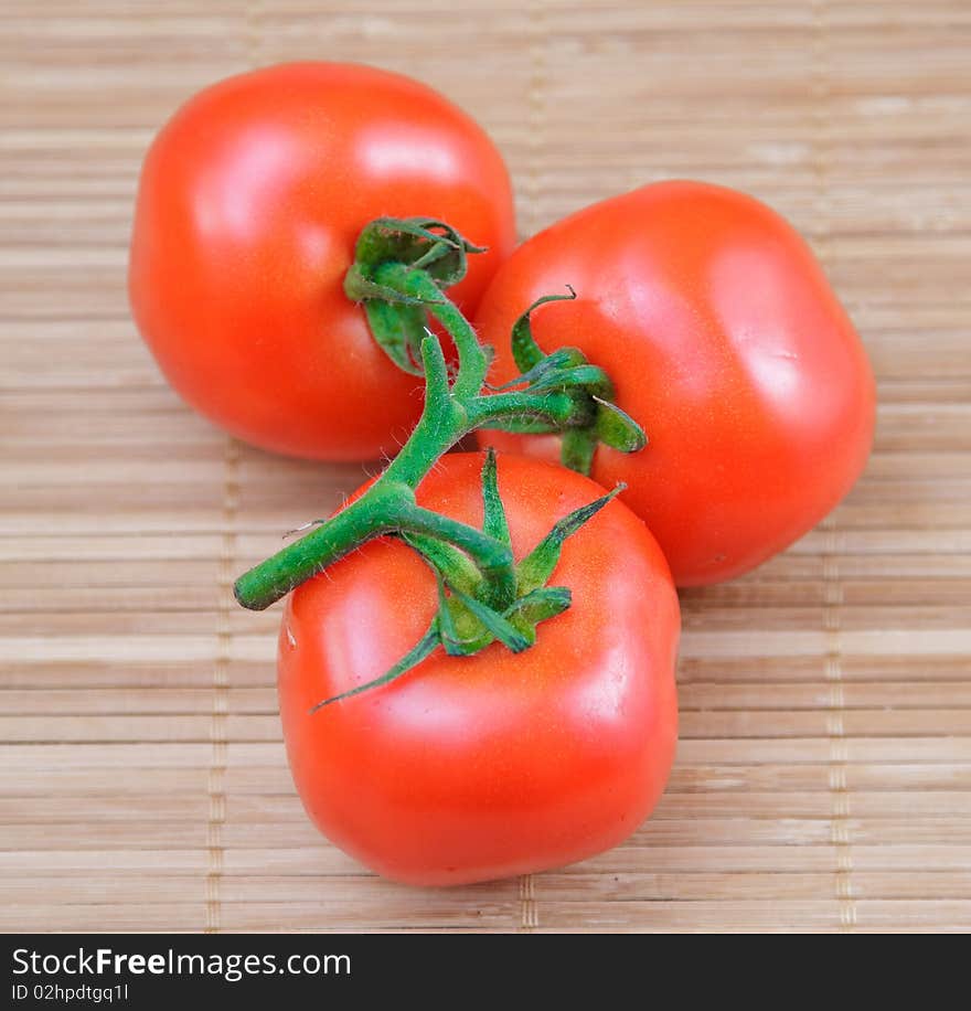 Red salad and tomato on brown bamboo napkin. Red salad and tomato on brown bamboo napkin