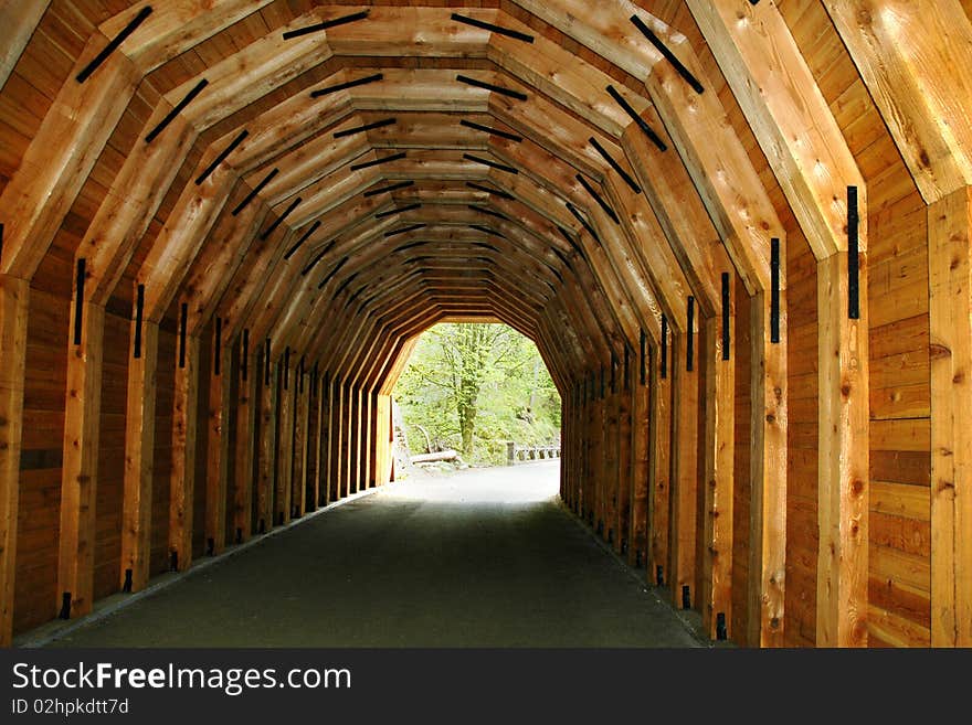 Looking down the middle of a wooden tunnel