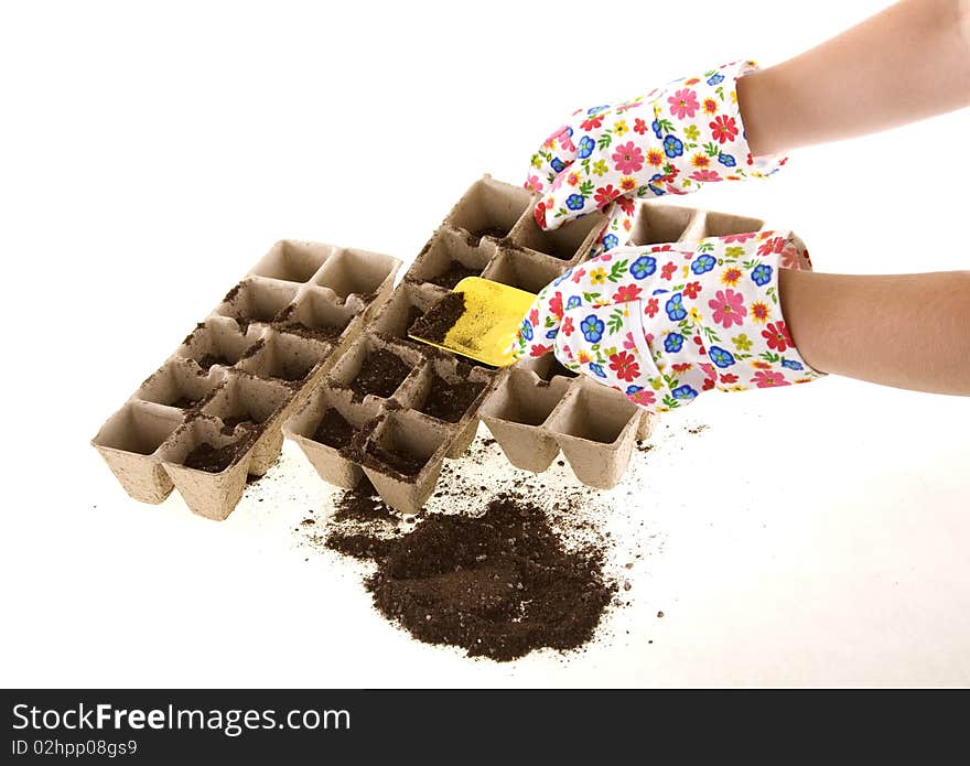 Gloves with Shovel Placing Soil into Compost Pots