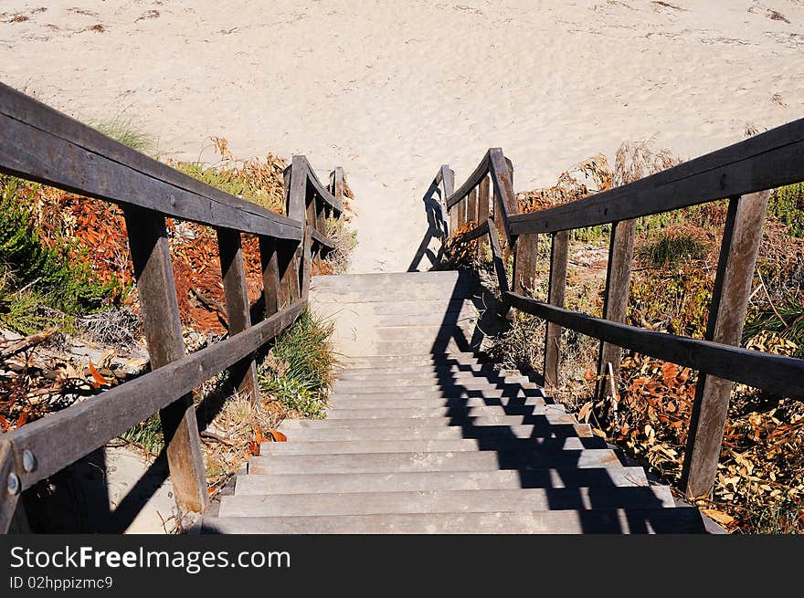 Stairs leading to the beach ends in the sand - can symbolize a variety of ways