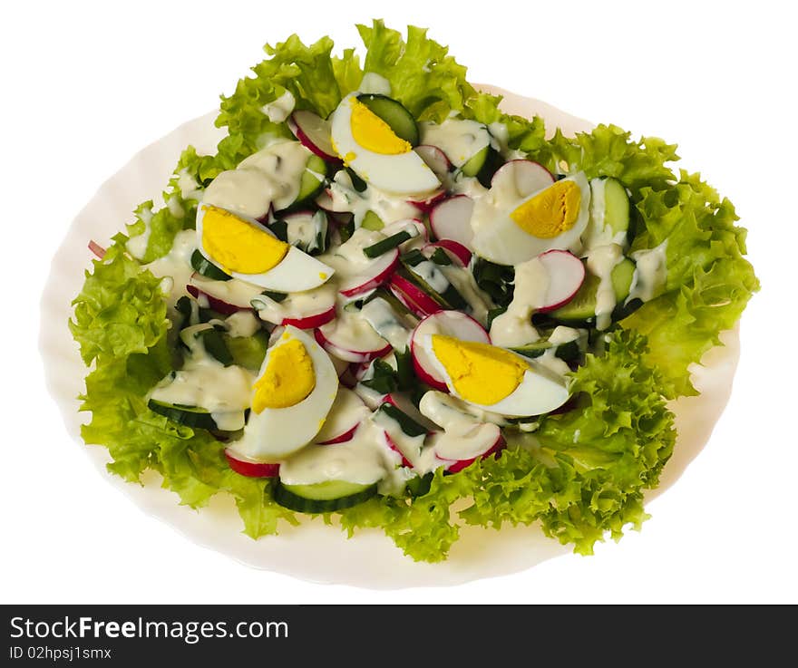 Salad with slice of egg on green lettuce. Plate isolated on white. Salad with slice of egg on green lettuce. Plate isolated on white