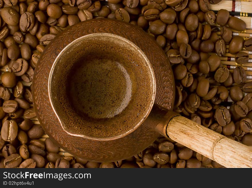 Coffee beans and old jezve. View from above.