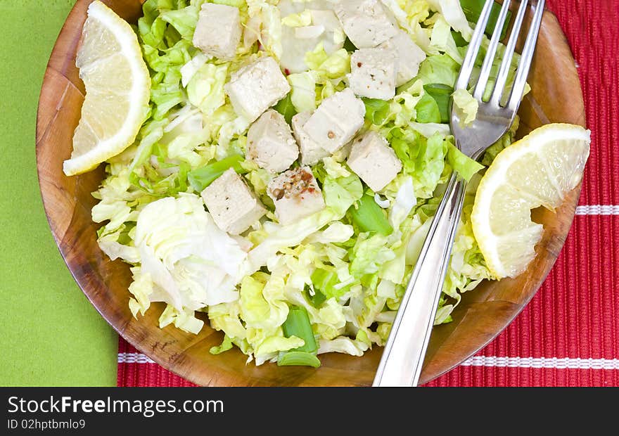 Closeup on a bamboo bowl with salad. Closeup on a bamboo bowl with salad