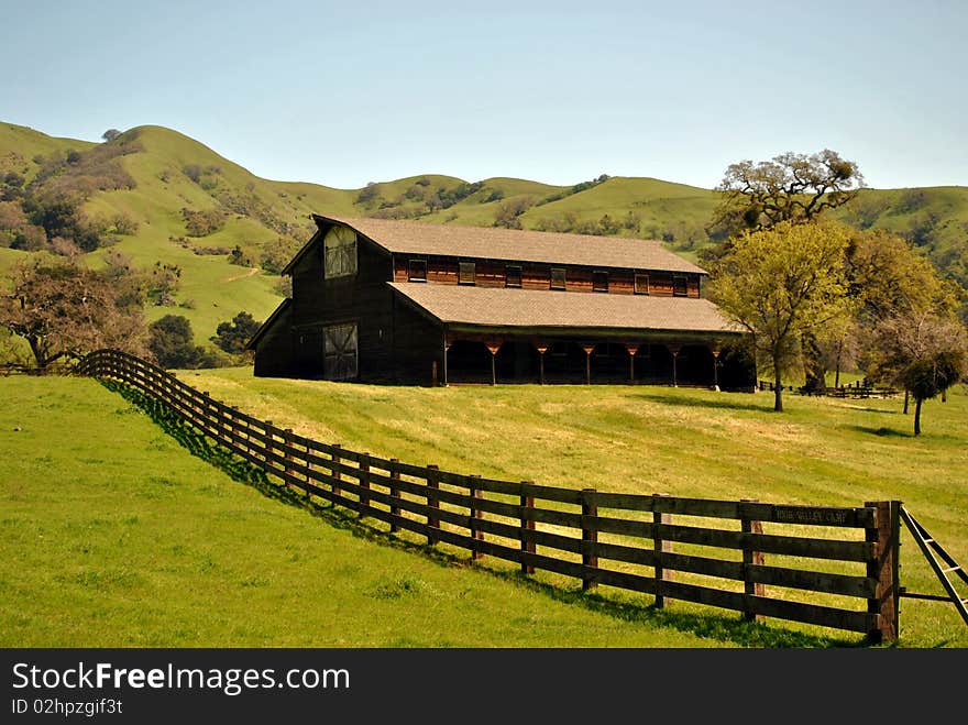 Old ranch barn in the green meadow hills. Old ranch barn in the green meadow hills.