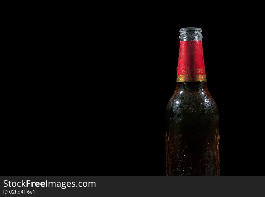 Wet beer on a black background with lots of empty space. Wet beer on a black background with lots of empty space.